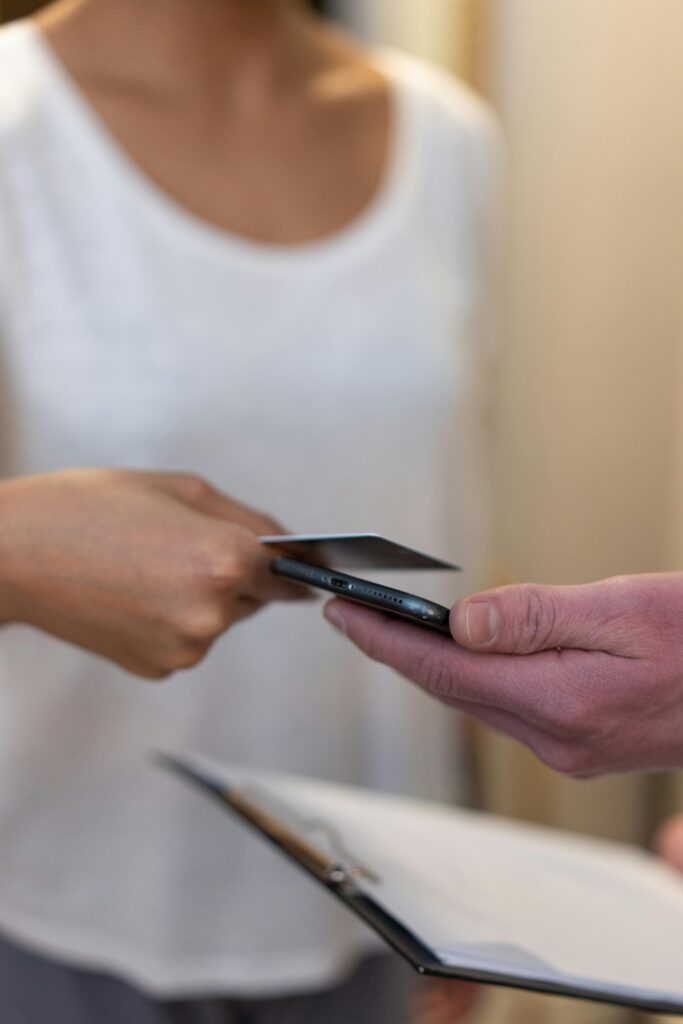 Hands Holding Credit Card and Smartphone